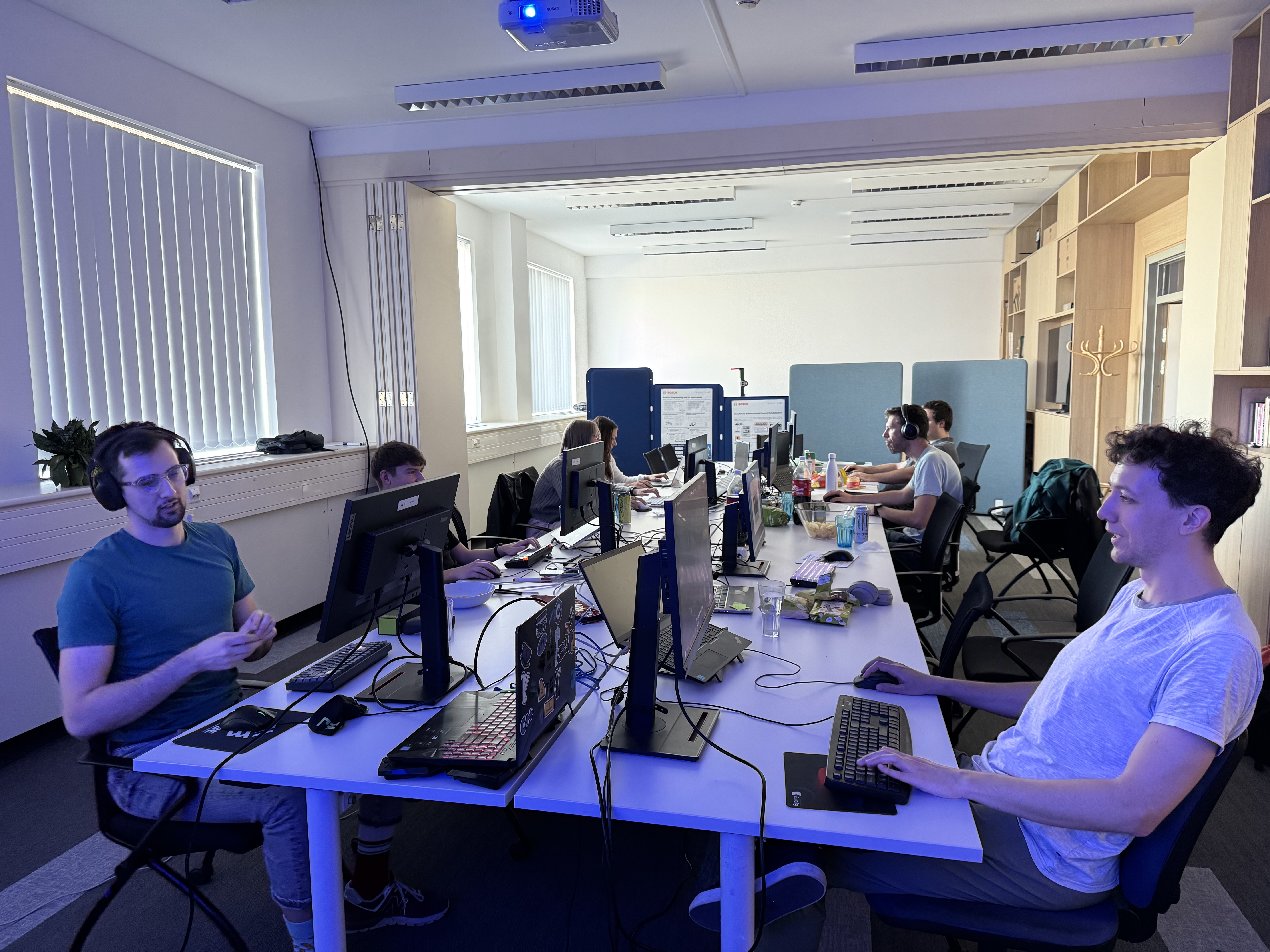 The LAN party setup with multiple screens and participants